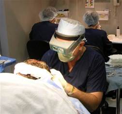 Dr. Griffin making incisions under 7-power magnification